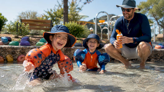 Children playing outdoors in sun-protective clothing
