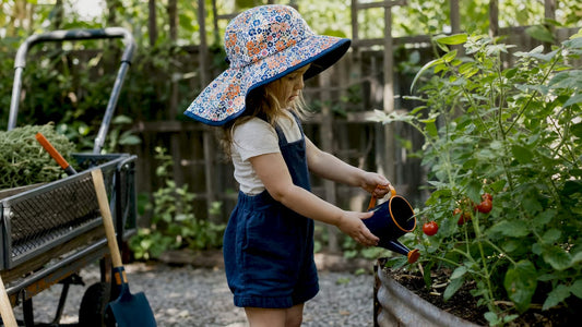 Toddler girl outdoors wearing wide brim hat for sun protection