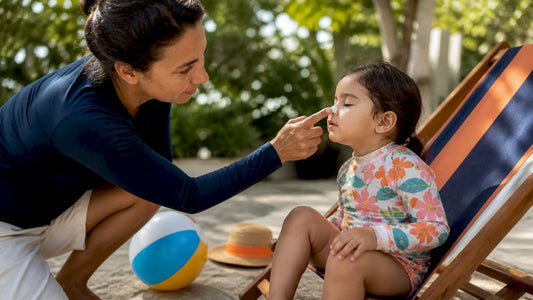 Parent applying sunscreen to child by pool