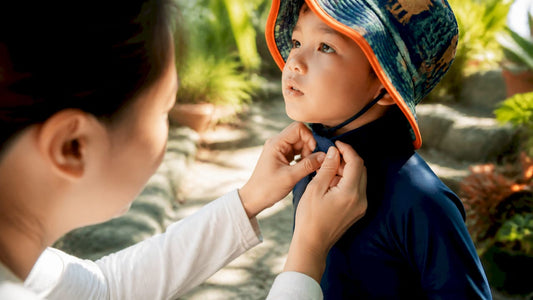Parent adjusting child's sun-protective shirt sleeve